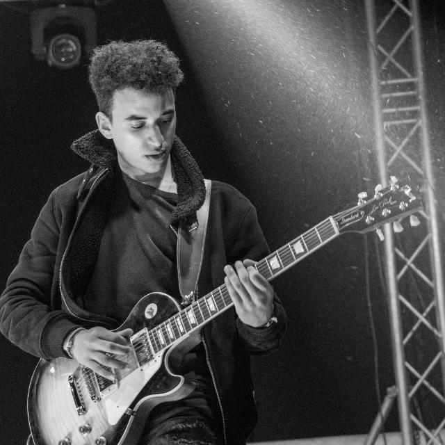 Youssef Farouk playing electric guitar on stage